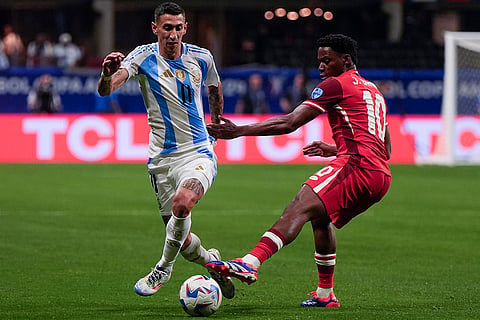 Angel Di Maria and Jonathan David battle for the ball 